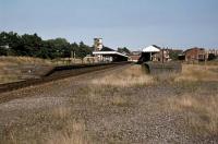 By the 1970s, there was a major mismatch between the size of Felixstowe (formerly Felixstowe Town) station and the remaining passenger traffic on offer. This view of the station was taken on 4th September 1977 and shows how the facilities dwarfed the regular 2 car DMU that worked the service to Ipswich. In the 1980s, the station was effectively cut in half, so that trains could terminate short of the main building and allow it to be converted into a shopping centre. The island platform on the right and the goods shed were demolished completely.<br><br>[Mark Dufton 04/09/1977]