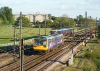 Units racing along the WCML south of Farington Junction towards Leyland on 2 May. On the up fast line in the background is a TPE unit heading for Manchester Airport (next stop Chorley), whilst in the foreground on the up slow line is a Northern service to <br>
Manchester Victoria (next stop Leyland).<br><br>[John McIntyre 02/05/2011]