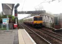 Looking towards the Clyde from Anniesland as 318258 crosses the girder bridge over the Great Western Road on a service for Dalmuir. The colour light signal in the foreground controls Hyndland North Jcn with the <I>feather</I> being for the single line chord to Hyndland West Jcn, mainly used for ECS Yoker movements.<br><br>[Mark Bartlett 14/04/2011]