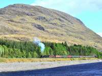 On a glorious day in bright sunshine, K4 61994 <I> The Great Marquess </I> and 37676 <I> Loch Rannoch </I> haul <I> The Cathedrals Explorer </I> along the side of Loch Treig south of Tulloch on 8 May. Stob Coire Sgriodain (979 Metres) is the peak in the background. <br><br>[John Gray 08/05/2011]