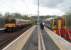 Conversation at Anniesland. The crew of 158738 chat before returning to Glasgow Queen St via Maryhill while 318257 leaves on a service to Milngavie.<br><br>[Mark Bartlett 14/04/2011]