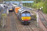 DRS 66418 heads north through Dunblane station on 10 May with the 4A13 Grangemouth - Aberdeen Intermodal freight. The train has just passed 170430 standing at platform 1 about to depart on a sevice to Glasgow Queen Street.<br>
<br><br>[Bill Roberton 10/05/2011]