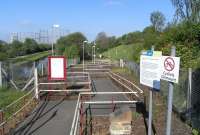 The only pedestrian access to the platform at Kelvindale is via this <br>
multi right-angled path. Whether it is designed to dissipate the slope I don't know, but you do expect to find a large lump of cheese at the end of it. The Forth & Clyde canal and the delicate-looking girders of the Dawsholm gasometers complete the scene.<br><br>[David Panton 02/05/2011]