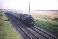 Fairburn 2-6-4T no 42194 heads an Ayr - Glasgow train north on 21 August 1959 on the approach to Troon station. Lochgreen Junction and the Troon avoiding line can be seen in the background.<br><br>[A Snapper (Courtesy Bruce McCartney) 21/08/1959]