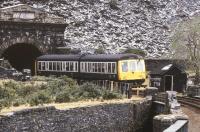 A DMU from Llandudno approaching Blaenau Ffestiniog through a landscape of slate in May 1990.<br><br>[Ian Dinmore /05/1990]