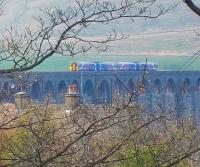 A Northern DMU crosses Ribblehead Viaduct on 18 April on the approach to Ribblehead station. Judging from the buds on the nearest trees, such a photograph would not be obtainable from this spot a week or so later.<br><br>[Andrew Wilson 18/04/2011]