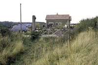 The closed station at Attlebridge passed into private ownership in the late 1970s and by the date of this photograph, 13th October 1979, had substantially changed in appearance following conversion into a dwelling house [see image 25122 for comparison]. The nearest level crossing gate has long gone, but remnants of the other still persisted within a roadside hedge in 2010.<br><br>[Mark Dufton 13/10/1979]