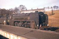 Britannia Pacific no 70018 <I>Flying Dutchman</I> on the 12 noon Edinburgh-Carlisle at Riccarton Junction on 6th November 1961. This class was a daily sight on the Waverley Route during the brief sojourn of 70018 and classmate 70016 <I>Ariel</I> at Carlisle Canal Shed from September 1961 until May 1962, and then on a less regular basis while operating from Kingmoor between 1963 and November 1967, when the last known Britannia working over the line took place just a few weeks before the closure of 12A on 1st January 1968. [The young admirer is David Spaven.]<br><br>[Frank Spaven Collection (Courtesy David Spaven) 06/11/1961]