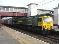 Freightliner 66534 <I>'OOCL Express'</I> powers north through platform 5 at Harrow & Wealdstone Station with a near full consist of containers in the early evening of 16 May, following a lay over in Wembley yard. <br><br>[David Pesterfield 16/05/2011]