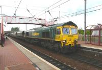 Freightliner 66513 powers through Whifflet on 11 May with 4C07 Longannet to Ravenstruther coal empties<br><br>[Ken Browne 11/05/2011]