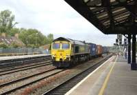 Freightliner 66543 speeds south through the centre road at Oxford station on 17 May with a container train.<br><br>[Peter Todd 17/05/2011]