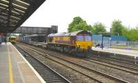 66020 takes containers north through the centre road at Oxford on 17 May, while a First Great Western DMU service to Paddington awaits its departure time at platform 1.<br><br>[Peter Todd 17/05/2011]