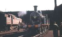 Evening scene in the shed yard at Dawsholm on 26 September 1959. Long time resident Stanier 2-6-2T no 40176 stands alomgside CR 123, one of several preserved locomotives based at Dawsholm at that time. The latter had been heavily involved during much of September hauling specials in connection with the Scottish Industries Exhibition [see image 30452].<br><br>[A Snapper (Courtesy Bruce McCartney) 26/09/1959]