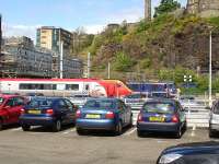 Virgin Voyager 221107 stands at the east end of Waverley at lunch-time on 10 May following arrival with the 08.20 service from Birmingham New Street. DBS ScotRail liveried 90024 lays over in the nearby east facing bay.<br><br>[David Pesterfield 10/05/2011]