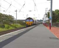 One of the DBS <I>Euro Cargo Rail</I> fleet no 66033 runs through Ardrossan South Beach at speed with 4J06 Longannet - Hunterston empty HTAs on 26 May 2011.<br><br>[Ken Browne 26/05/2011]