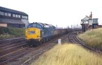 A rake of what at first glance appears to be 16t mineralwagons passes Bowesfield box to the west of Thornaby in October 1970 behind class 37 No. 6898. On closer inspection it can be seen that they are actually ironore tipplers, most likely conveying imported iron ore from South Bank to either Corby, Spring Vale (Wolverhampton) or Stanton Gate (Ilkeston), all of which were served from Teesside around that time. Interestingly there were also loaded back workings conveying ironstone from Northamptonshire to Hartlepool and Skinningrove. A number of ironstone quarries in the East Midlands were still operational in 1970, the last not ceasing production until 1980 when Corby steelworks closed.<br><br>[Bill Jamieson 02/10/1970]