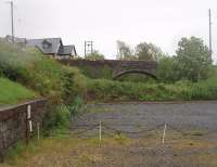 Most of the Glenluce station site has been built over since the 1965 closure of the <I>Port Road</I>. However, at the east end is a small car park overlooked by this road overbridge and with the low retaining wall still intact. View towards Newton Stewart.<br><br>[Mark Bartlett 23/05/2011]