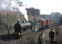 Class J37 0-6-0 no 64623 stands in the sidings at Ruchill with a BLS brake van tour on 27 March 1964, the year before closure. The short NB freight-only branch left the GD&H route just west of what is now Possil park and Parkhouse station. Brassey Street bridge spans the line in the background and the houses of Curzon Street stand top left.<br><br>[Andy Carr Collection 27/03/1964]