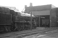 WD 2-8-0 No. 90417 is perhaps contemplating its eventual demise as it stands in the pouring rain in the yard at Sunderland South Dock in May 1967. Before the end of the year it would be cut up into small chunks and loaded into 16T mineral wagons, a fate awaiting it at the Hughes Bolckow yard in North Blyth. However at this time 90417 still had some 4 months of active service left, surviving until the end of steam at Sunderland in September of that year.<br><br>[Bill Jamieson 27/05/1967]