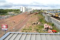 View west through a window of the footbridge at Edinburgh Park station on 31 May 2011. The area below is earmarked to become part of a train/tram/bus interchange, with trams from the city centre then taking the route north via the flyover in the background to reach Edinburgh Airport.<br><br>[John Furnevel 31/05/2011]