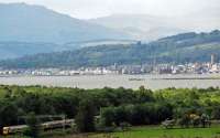 Just a short distance to go, a westbound service at Ardmore. Beyond is the derelict Craigendoran pier, Helensburgh (and its pier) and the hills of Argyll tempting us to travel on by the West Highland Line.<br><br>[Ewan Crawford 20/05/2011]