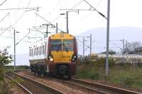 334034 with a service to Edinburgh Waverley approaching <br>
Geilston level crossing, west of Cardross on 28 May. The train has just crossed 334028, seen in the background heading for Helensburgh Central.<br><br>[John McIntyre 28/05/2011]