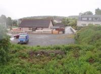 The old station site at Glenluce, as seen from the overbridge, on a very wet morning in May 2011. This view looks west towards Challoch Junction where the line from Girvan was joined. Although there is little trace of the station itself Glenluce viaduct, to the west of the village, still stands and is a fine monument to the <I>Port Road</I>. [See image 15291]<br><br>[Mark Bartlett 23/05/2011]