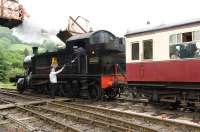 The fireman of ex-GWR 2-6-2T no 5526 collects the token on departure from Buckfastleigh, heading an Autocoach train, on 28 May 2011.<br><br>[Peter Todd 28/05/2011]