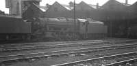 The shed yard at Kingmoor in the summer of 1967. Stanier 8F No. 48158 appears to have worked up to Carlisle from Leeds with a special Class 8 freight judging by the chalked reporting number on the smokebox. Why it should be running with a mini-snowplough, even over the S&C, in the middle of summer is not clear - but it wouldn't serve any further useful purpose as the loco didn't survive the demise of steam in the West Riding that autumn. <br>
<br><br>[Bill Jamieson 27/08/1967]