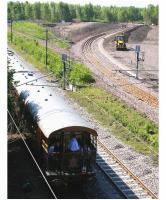 The north end of Millerhill in bright sunshine on 3 June 2011 looking south west from the road bridge. The new formation now ends at a buffer-stop, while the former turnback siding [see image 2874] has been lifted. Meanwhile, members of the crew of <I>'The Royal Scotsman'</I> enjoy some fresh air on the open rear deck as the empty stock enters the yard behind WCRC 57001.<br><br>[John Furnevel 03/06/2011]