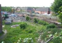 Photograph taken from alongside the A7 on 3 June 2011 looking south west over the site of the planned Newtongrange station on the Borders Railway route to Tweedbank. The houses of Jenks Loan in the background are part of a significant residential development on the west side of the trackbed here. The original Newtongrange station was located on the north side of the A7 behind the camera [see image 24342].<br>
<br><br>[John Furnevel 03/06/2011]