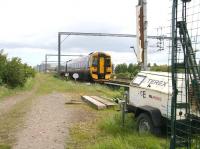 With Edinburgh Castle prominent on the horizon, the 10.58 Dunblane - Waverley DMU has just passed the site of the former Balgreen Halt and is approaching Haymarket West Junction on 31 May 2011. At this point the lines are parallel with the planned tram route from the airport, running straight ahead on the left towards Murrayfield.<br><br>[John Furnevel 31/05/2011]