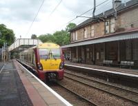 334017 pulls away from Bearsden heading along the short double track section to Hillfoot that sits in the middle of the mainly single track Milngavie line. This <I>dynamic loop</I> allows an intensive service to be operated on the branch. The original station building is now a pub/restaurant and the small modern ticket office and waiting room is just beyond it on the Up platform.<br><br>[Mark Bartlett 25/05/2011]