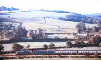 A BR class 33 with a Waterloo - Barnstaple train passing Umberleigh, North Devon, on 13 September 1985. The leading vehicle is a newspaper van.<br><br>[Ian Dinmore 13/09/1985]