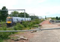 The site of Balgreen Halt on the old Corstorphine branch looking west on 31 May 2011. This is the planned location of Balgreen tram stop. The trackbed of the Corstorphine branch (now a walkway) curves away to the right towards Pinkhill and Corstorphine, while the new tram formation runs straight ahead alongside the E&G main line. [See image 48054]<br><br>[John Furnevel 31/05/2011]