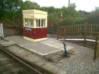 Stop me if I'm missing something, but shouldn't the hut be built over the ground frame, to keep you dry while you're switching points? Scene at Bitton on the Avon Valley Railway in May 2011. The tarmac visible beyond the fence is the bikepath, which switches sides at this point, continuing towards Bath past Avon Riverside halt [see image 22957].<br><br>[Ken Strachan 29/05/2011]