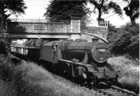 A train of empty 16T mineral wagons return from the Courtaulds plant at Ribbleton (Red Scar) behind Stanier 8F 2-8-0 48438. The train is passing under the ornate Cromwell Road bridge where the inscription on the bridge parapet reads <I>'Erected by Ribbleton Freehold Land Society 1863'</I>. [See image 34400] for a present day view of the same location. [Picture by kind permission of Peter Fitton]<br><br>[David Hindle Collection 04/07/1966]