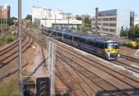 A Heathrow Express bound for Paddington runs past the camera towards West Ealing station on 4 June 2011. On the far left is the Greenford line.<br><br>[John McIntyre 04/06/2011]