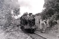 GWR 6619 setting off for Grosmont with a train in July 1986, passing sections of a footbridge stored alongside the line just before the level crossing north of Pickering station.<br><br>[Colin Miller /07/1986]