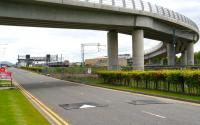 An Edinburgh - Glasgow shuttle runs west through Edinburgh Park on 31 May 2011. The train is about to pass below the flyover built to carry trams over the E&G on the route to the airport.<br><br>[John Furnevel 31/05/2011]