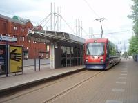 Metro tram No. 15 is seen at the Wolverhampton town centre terminus, known as St Georges, shortly after arrival from Birmingham Snow Hill on 8 June 2011. Most of the tram route follows the course of the old Great Western main line from Snow Hill, but from Priestfield into Wolverhampton is a street running section. <br><br>[Mark Bartlett 08/06/2011]