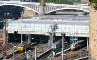 Sunday morning view over Waverley east end on 12 June 2011 showing the ongoing work on the roof panel project [see image 28808]. Down below, sleeper 'regular' EWS 90036 is stabled in the locomotive bays, while North Berwick units 322485 and 'new kid on the block' 380104 stand alongside. The 2 north side through platforms are unavailable for normal traffic at this time due to the ongoing works.<br><br>[John Furnevel 12/06/2011]