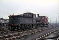 J36 no 65345 stands in the yard at Bathgate, thought to be around 1966/67. View is west towards the now demolished North British foundry [see image 24018]. The locomotive was one of the last 2 steam locomotives in Scotland (along with 65288) to be 'officially' withdrawn by BR in June 1967.<br><br>[Andy Carr Collection //]