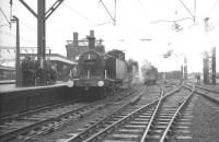 A wet day at Stockport as 47202+47383 stand at the platform with the MRTC <I>Three Counties Special</I> on 26 November 1966. The pair had recently brought in the train from Bury Bolton Street [see image 28968] and were preparing to hand over to Ivatt 2-6-2T no 41204, standing on the right, for the next leg of the tour to Buxton.<br><br>[K A Gray 26/11/1966]