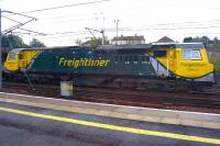 Freightliner 70011 pulls out of down goods loop at Carstairs on 19 May 2011. Taken from the 09.50 Glasgow Central - Kings Cross train. The side view conveys the considerable overall length of these locomotives.<br>
<br><br>[Colin Miller 19/05/2011]