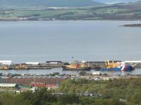 Two for the price of one! View north over the site of Greenock Ladyburn shed towards the Clyde on 6 June 2011, with a class 380 passing along the bottom of the picture on a Gourock - Glasgow Central service. The particularly sharp eyed may notice a second train in the photograph on the north bank, where a Class 334 has just left Craigendoran on its way from Helensburgh to Edinburgh Waverley.<br>
<br><br>[Graham Morgan 06/06/2011]