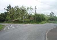 Little now remains of Wigtown station, situated at the south east corner of <I>Scotland's Book Town</I>. This old overbridge still spans the Whithorn branch cutting, now full of trees, with the station at the end of a driveway that started at the gate on the right. Wigtown closed to passeners in 1950, although goods trains continued until 1964. Photographed in May 2011. [See image 27486] for the view from the bridge in 1965. <br><br>[Mark Bartlett 26/05/2011]