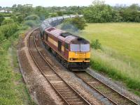 The Preston Docks to Lindsey Oil Terminal empty bitumen tank train <br>
climbing from the WCML at Farington Curve Junction and approaching Lostock Hall on 17 June 2011. The Preston skyline can be seen at the top right of the photograph amongst the trees. The sight of Class 60 no 60024 on this working was a pleasant change from the usual Class 66.<br>
<br><br>[John McIntyre 17/06/2011]