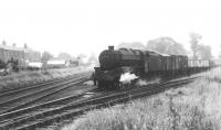 Stanier 5MT 4-6-0 45043 prepares to draw its train out of Longridge Goods Yard prior to running round and taking the train, tender first, back down the branch to Preston. This picture was taken in 1966, the year before final closure. Just to the left of the loco the signal box can be seen controlling the level crossing at the station. [See image 34581] for the same location today. [Photograph courtesy Brian Bamber]<br><br>[David Hindle Collection //1966]