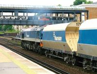 <i>'...complete with full matching accessories.'</I> Hanson Aggregates Class 59 no 59104 takes the centre road through Kensington Olympia on the West London Line on  22 July 2005 with a company train heading north towards Willesden Junction. The station footbridge appears to be 'in transition' at this time.<br>
<br><br>[John Furnevel 22/07/2005]